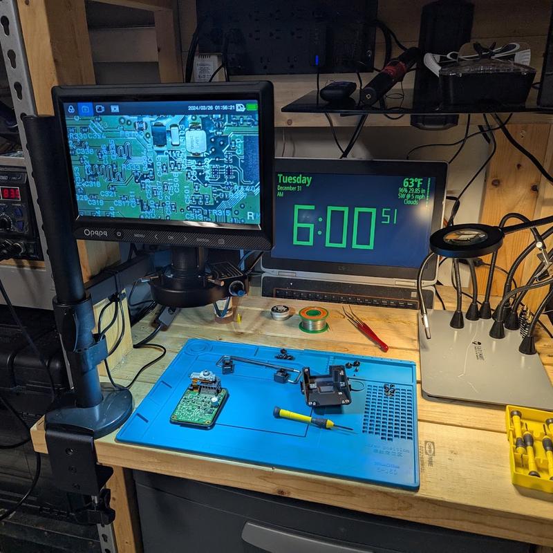 A real soldering and test bench with a hot air rework station and digital microscope